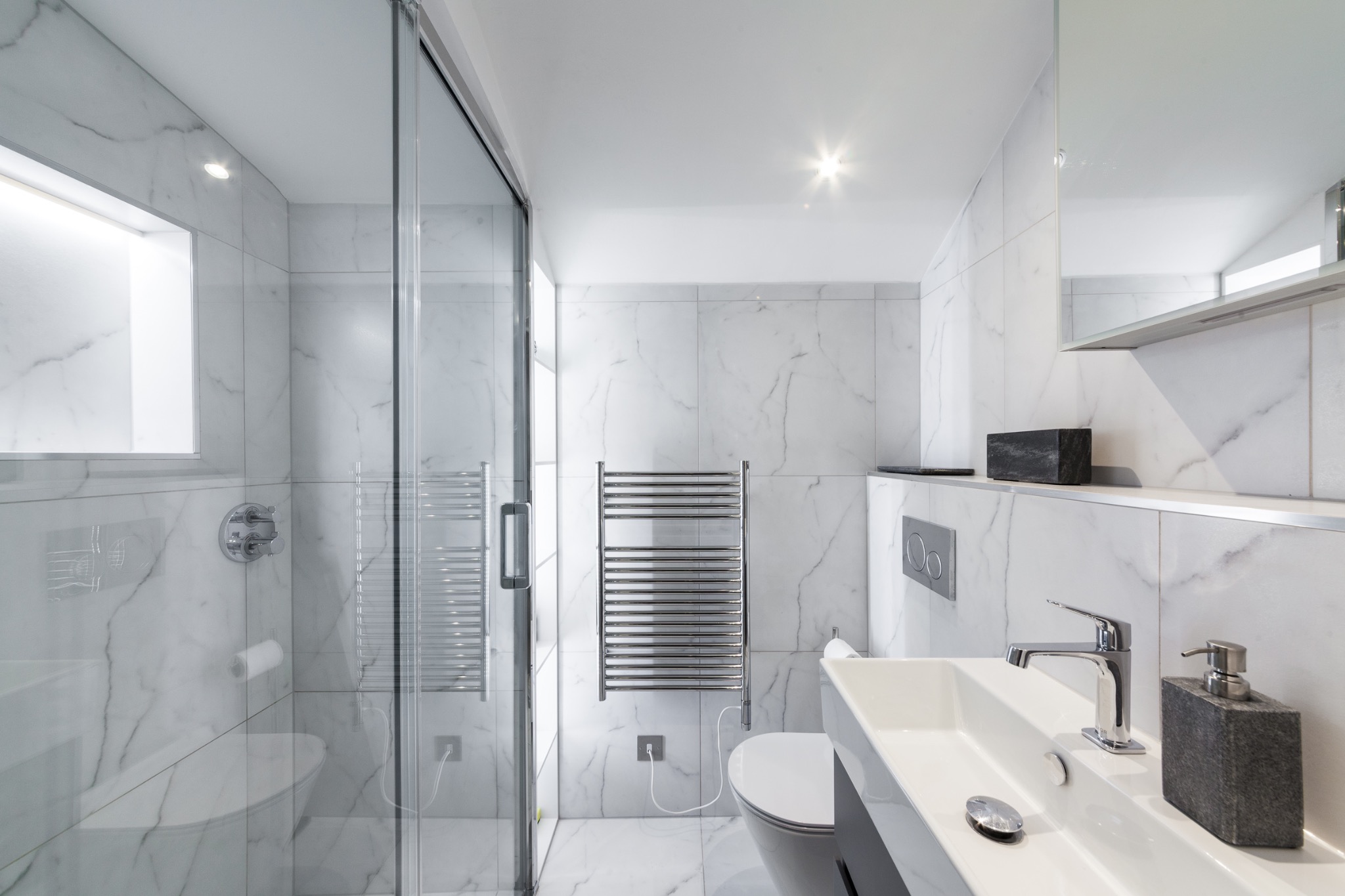 Chelsea marble bathroom with glass shower and chrome fittings