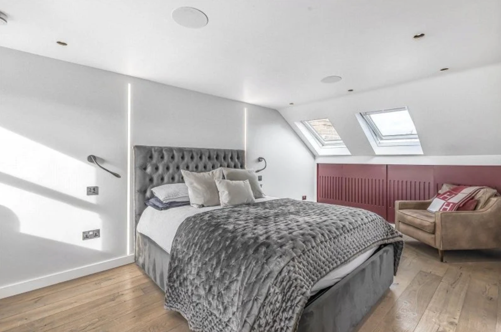 Imperial Wharf principal bedroom with upholstered bed, rooflights and bespoke joinery