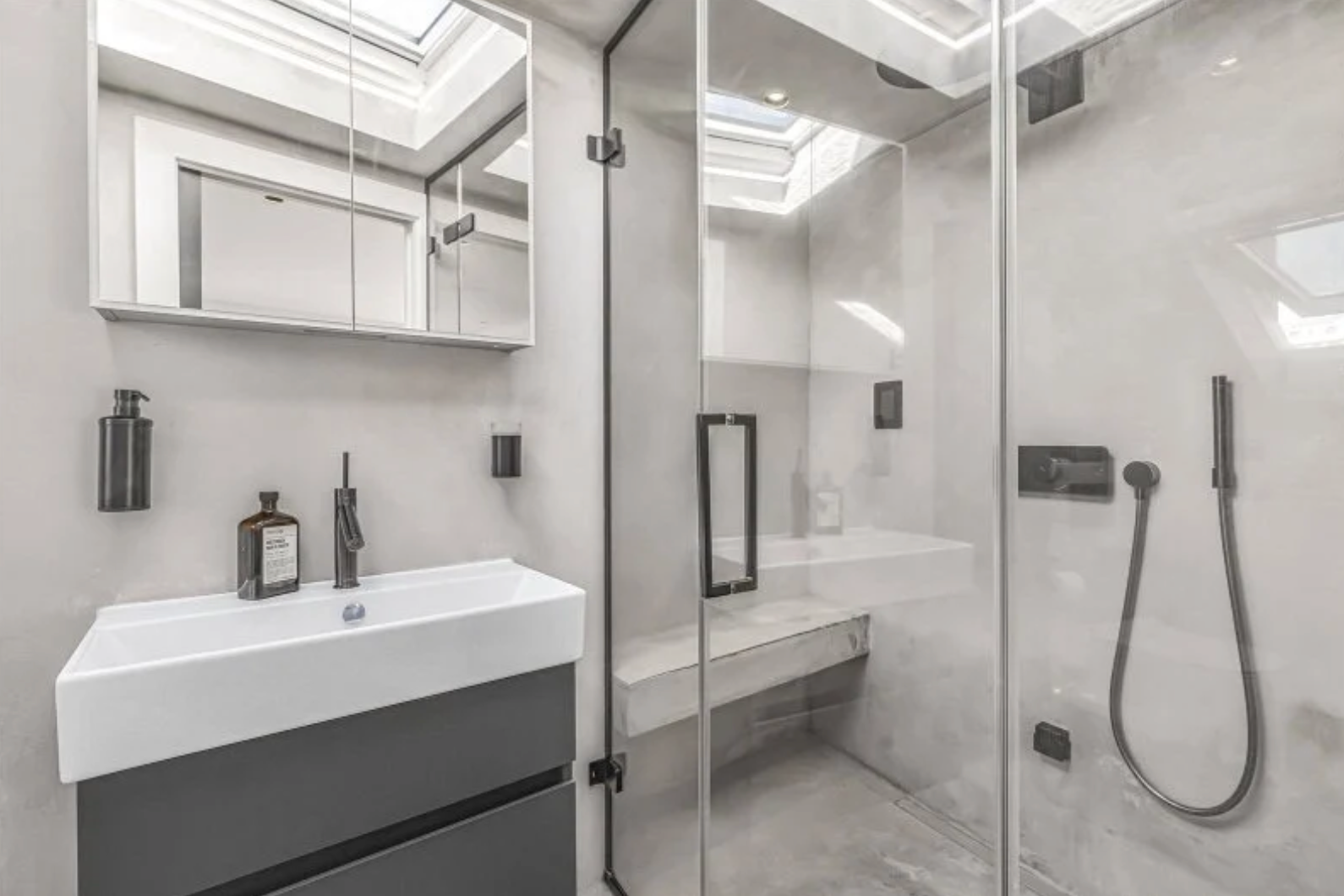 Imperial Wharf marble en-suite shower room with rooflight and black fittings