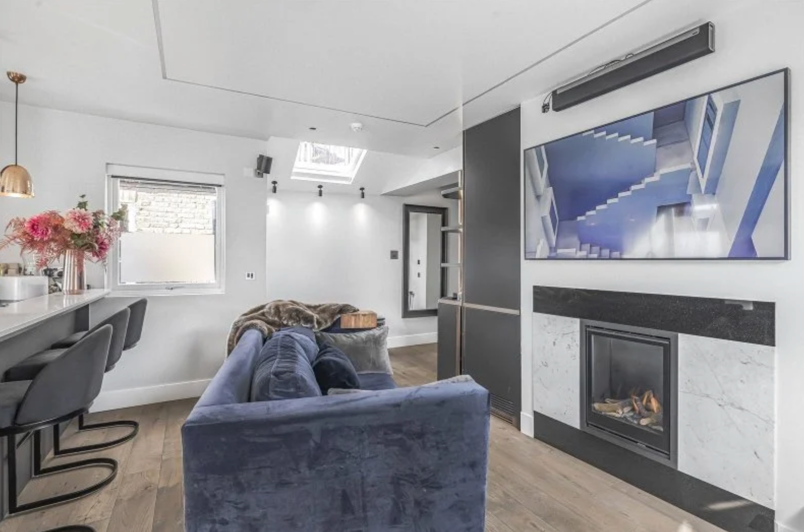 Imperial Wharf living room with integrated fireplace, television and bespoke cabinetry