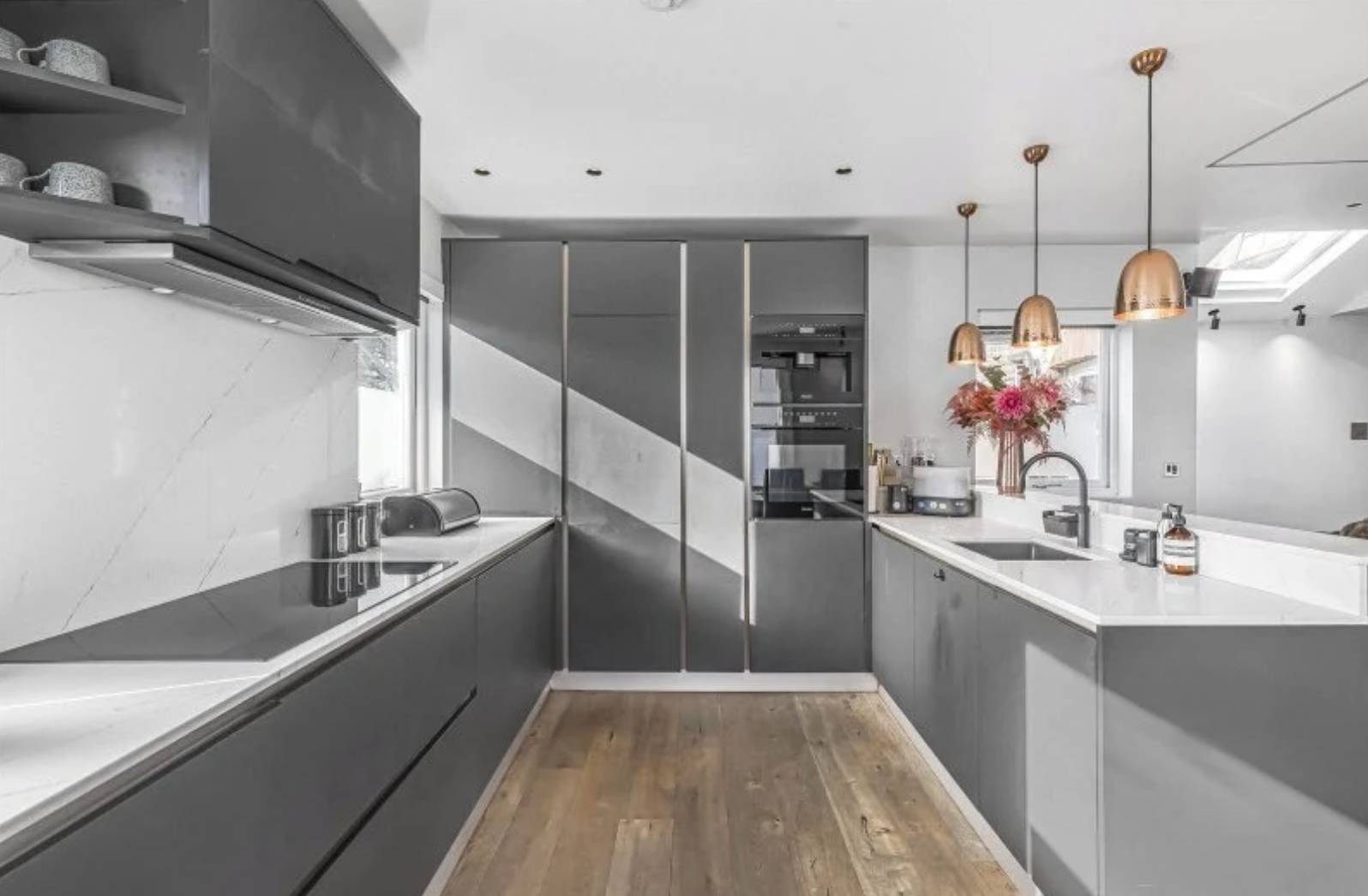 Imperial Wharf contemporary grey kitchen with marble-effect splashback and bronze pendant lights
