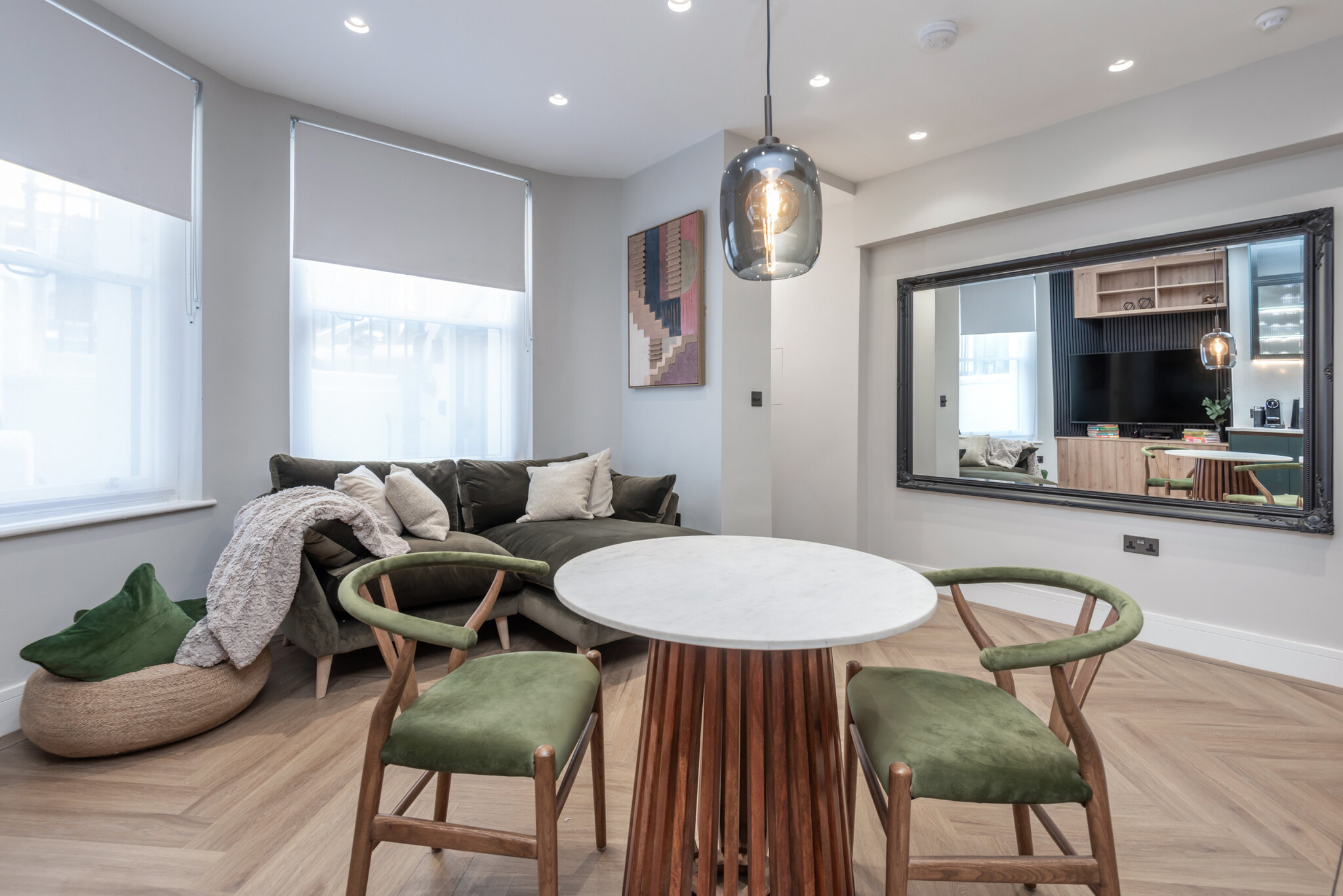 Portobello Road living and dining room with olive seating and herringbone flooring