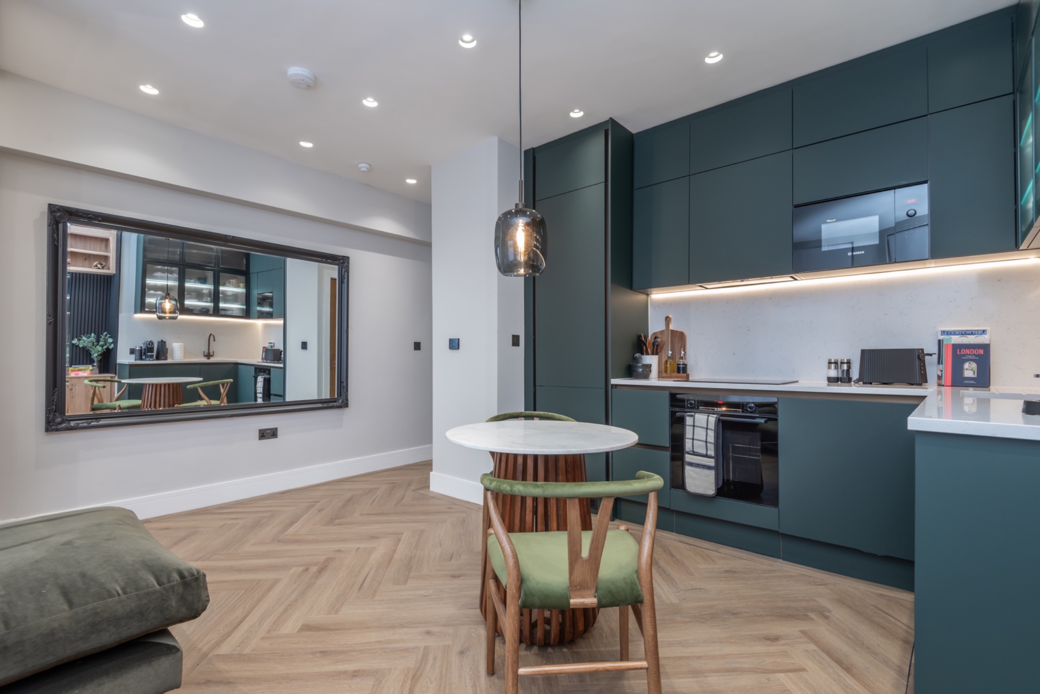 Portobello Road open-plan kitchen with deep green cabinetry